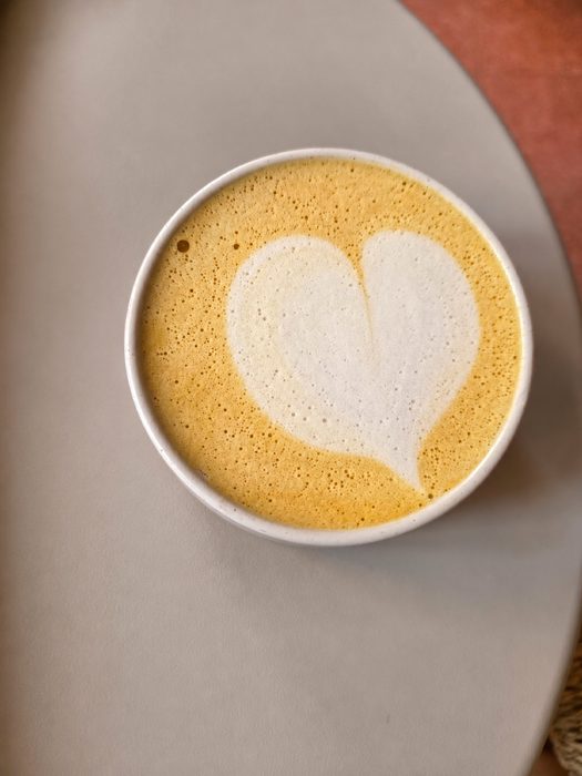 A latte with heart-shaped foam art