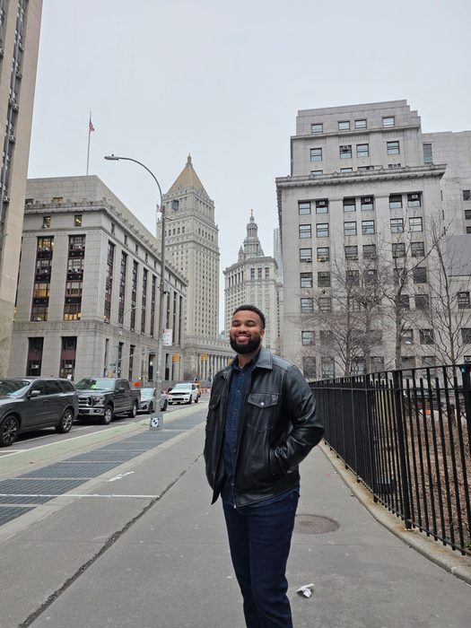 Usoff Samantar smiling on a New York City street